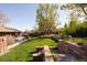 The terraced backyard landscaping includes stone retaining walls, garden steps and an outdoor seating area at 26 Morningside Dr, Wheat Ridge, CO 80215