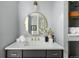 Bright bathroom featuring a round mirror, modern vanity, and stylish decor at 26 Morningside Dr, Wheat Ridge, CO 80215