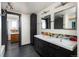 Modern bathroom with dual sinks, dark cabinetry, and stylish fixtures at 26 Morningside Dr, Wheat Ridge, CO 80215