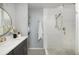 Modern bathroom with white subway tile shower, grey vanity and patterned tile floors at 26 Morningside Dr, Wheat Ridge, CO 80215