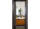 Bathroom with stylish colorful tilework, wood cabinet and modern fixtures at 26 Morningside Dr, Wheat Ridge, CO 80215