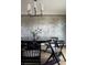 Modern dining room features a black table, stylish chairs, and unique lighting fixture at 26 Morningside Dr, Wheat Ridge, CO 80215