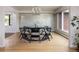 Elegant dining room featuring a round table, modern chandelier, and large windows at 26 Morningside Dr, Wheat Ridge, CO 80215