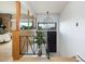 Modern entryway featuring wood accents, unique light fixture, and a view of the landscape at 26 Morningside Dr, Wheat Ridge, CO 80215