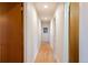 Hallway with hardwood floors and white walls, featuring doors and a framed picture at 26 Morningside Dr, Wheat Ridge, CO 80215