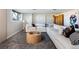 Comfortable living room showcasing a large sectional sofa, round wood coffee table, and modern art at 26 Morningside Dr, Wheat Ridge, CO 80215