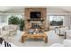 Open living room with stone fireplace, large windows, and stylish furniture at 26 Morningside Dr, Wheat Ridge, CO 80215