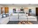 Bright living room featuring a large sectional sofa, stylish art, and trendy decor at 26 Morningside Dr, Wheat Ridge, CO 80215