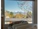 Picturesque mountain view from a large window with comfortable seating at 26 Morningside Dr, Wheat Ridge, CO 80215