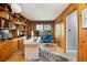 Spacious office with custom wood built-ins, statement rug, and a bright workspace at 26 Morningside Dr, Wheat Ridge, CO 80215
