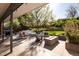 A covered patio space includes an outdoor sofa and chairs, a gas grill, and a gas fire pit at 26 Morningside Dr, Wheat Ridge, CO 80215