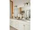 Bright bathroom featuring double sinks with vanity, decorative lighting, and modern fixtures for a clean and stylish space at 6153 N Ceylon St # 205, Denver, CO 80249