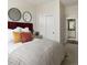 Cozy bedroom featuring a plush bed with decorative pillows, modern lighting, and stylish decor at 6153 N Ceylon St # 205, Denver, CO 80249