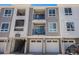 Modern townhome with a private balcony, garage, and contemporary gray and white exterior design at 6153 N Ceylon St # 205, Denver, CO 80249