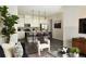 Open-concept living space with kitchen, living room featuring modern decor and hardwood flooring for a bright and inviting area at 6153 N Ceylon St # 205, Denver, CO 80249
