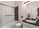 Modern bathroom featuring sleek fixtures, a shower-tub combo, and stylish vanity at 4574 S Cimmarron Cir # B, Aurora, CO 80015