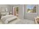 Serene bedroom with a sliding glass door, plush carpet, and a bright window at 4574 S Cimmarron Cir # B, Aurora, CO 80015