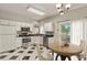 Bright kitchen with white cabinets, black countertops, and a cozy dining area at 4574 S Cimmarron Cir # B, Aurora, CO 80015
