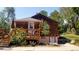 The backyard boasts a wooden deck surrounded by sunflowers and a well-manicured lawn at 8211 Rocky Mountain Dr, Lakewood, CO 80214