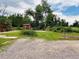 Large backyard featuring mature trees, garden beds, and a charming storage shed at 8211 Rocky Mountain Dr, Lakewood, CO 80214