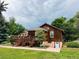 A charming backyard scene with a spacious deck, lush greenery, and access to the lower-level entrance at 8211 Rocky Mountain Dr, Lakewood, CO 80214