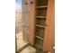 Neutral-toned bathroom with shower and built-in shelves to the side for storage and organization at 8211 Rocky Mountain Dr, Lakewood, CO 80214