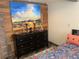 Bedroom featuring wood wall paneling, rustic touches, and comfortable furnishings at 8211 Rocky Mountain Dr, Lakewood, CO 80214