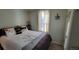 Comfortable bedroom featuring a queen bed with floral patterned comforter, soft lighting, and closet at 8211 Rocky Mountain Dr, Lakewood, CO 80214