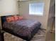 Bedroom with queen-size bed, cozy rug, and natural light from the window at 8211 Rocky Mountain Dr, Lakewood, CO 80214