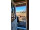 Covered back deck with seating and barbecue, great for entertaining outdoors at 8211 Rocky Mountain Dr, Lakewood, CO 80214