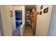 Carpeted hallway showcasing built-in bookshelves and an open view into a cozy bedroom at 8211 Rocky Mountain Dr, Lakewood, CO 80214
