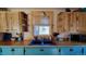 Close up of the kitchen showcasing painted cabinets, butcher block countertops, and garden window above the sink at 8211 Rocky Mountain Dr, Lakewood, CO 80214