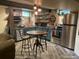 Charming kitchen boasts stainless steel appliances, floating shelves, and adjacent breakfast nook at 8211 Rocky Mountain Dr, Lakewood, CO 80214