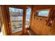 Cozy mudroom with wood paneling, built-in bench, and natural light streaming through the glass paneled front door at 8211 Rocky Mountain Dr, Lakewood, CO 80214
