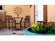 Cozy outdoor patio with seating area and colorful potted flowers; perfect for relaxation and entertaining at 8211 Rocky Mountain Dr, Lakewood, CO 80214