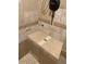 Shower features unique tile design, built-in bench, and modern fixtures at 8211 Rocky Mountain Dr, Lakewood, CO 80214
