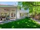 Backyard of home with patio and mature trees with lots of shade on a sunny day at 400 S Steele St # 13, Denver, CO 80209