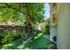 Landscaped backyard with mature trees and stone wall offers a private outdoor space at 400 S Steele St # 13, Denver, CO 80209