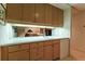 Well-lit bar area with light wood cabinets and sink perfect for entertaining guests at 400 S Steele St # 13, Denver, CO 80209