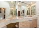 Bathroom vanity featuring double sinks, tile countertops and a large mirror at 400 S Steele St # 13, Denver, CO 80209