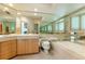 Bathroom featuring a large mirror, bathtub, toilet and tiled countertop with sink at 400 S Steele St # 13, Denver, CO 80209