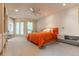 Bright bedroom featuring a ceiling fan and access to a sunroom through shuttered glass doors at 400 S Steele St # 13, Denver, CO 80209