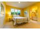 Sunny bedroom with a traditional bed frame and large windows at 400 S Steele St # 13, Denver, CO 80209