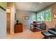 Well-lit home office with neutral walls, a large window, and a comfortable chair at 400 S Steele St # 13, Denver, CO 80209