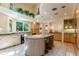 Bright kitchen with granite countertops, island with bar seating, and recessed lighting at 400 S Steele St # 13, Denver, CO 80209