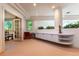 Spacious living area with built in shelving, lush plantings and neutral carpeting at 400 S Steele St # 13, Denver, CO 80209