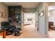 Bright office with built in book shelves and a view into the living room at 400 S Steele St # 13, Denver, CO 80209