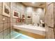 Modern powder room features a stone-look wall, a vessel sink, and a white door at 400 S Steele St # 13, Denver, CO 80209