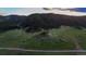 Aerial view of property in secluded location featuring trees, grass and meandering driveway at 15533 S Perry Park Rd, Palmer Lake, CO 80133