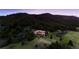 Stunning hillside estate surrounded by lush green trees and manicured landscaping at 15533 S Perry Park Rd, Palmer Lake, CO 80133